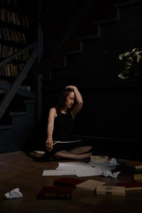 Portrait of young woman sitting on table