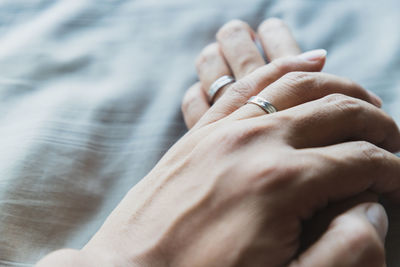 Midsection of couple holding hands