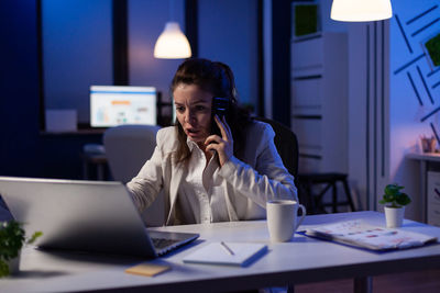 Young woman using laptop on table