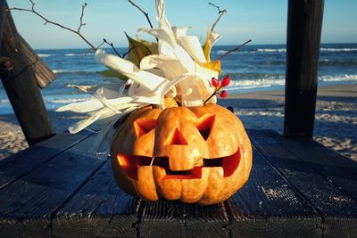 Pumpkin on table against sea during sunset