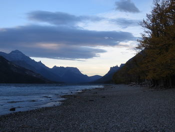 Scenic view of sea and mountains against sky