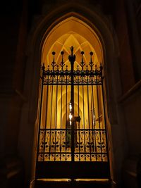 Low angle view of illuminated lamp in building