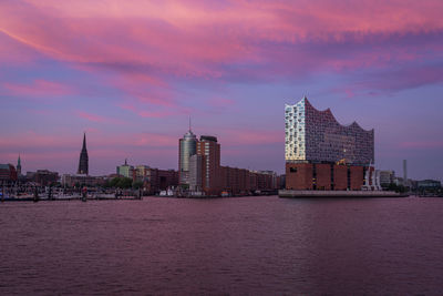 A colorful sunset from hamburg waterfront in germany with the elbphilharmonie building in front