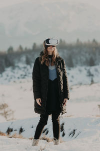 Young woman standing on snow