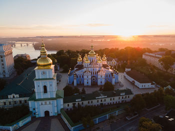 High angle view of buildings in city at sunset