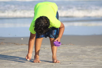 Rear view of girl on beach