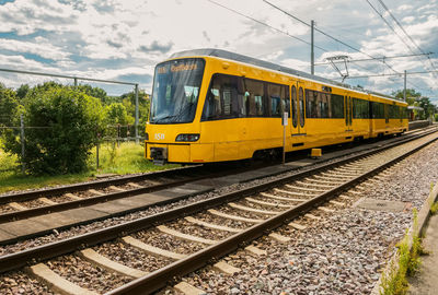 Train on railroad track against sky