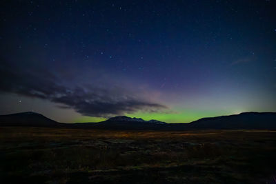 Scenic view of mountains against sky at night