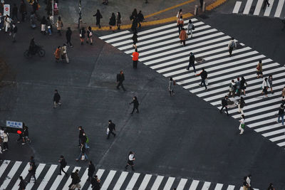 High angle view of people crossing road