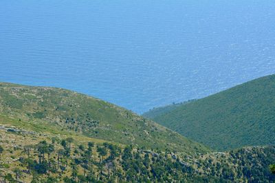 High angle view of land and sea against sky