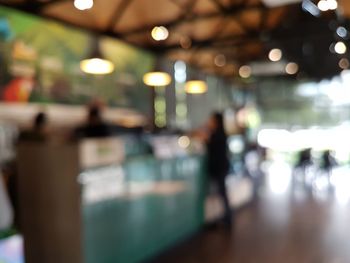 Defocused image of illuminated lights at restaurant