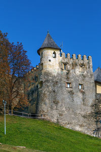 Low angle view of historic building against blue sky