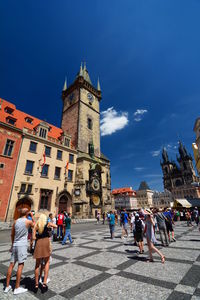 Buildings in city against blue sky