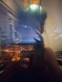 Man photographing illuminated city at night