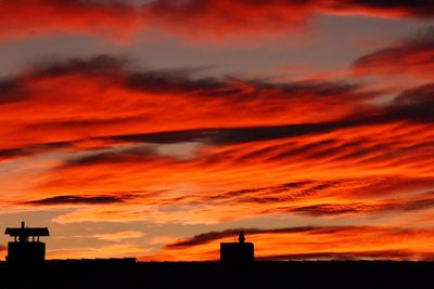 Silhouette built structures against scenic sky