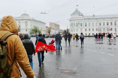 People walking on wet street in rainy season