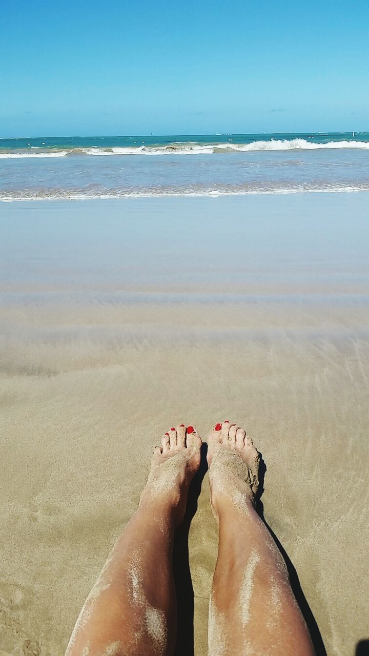 beach, sea, sand, water, horizon over water, shore, low section, person, vacations, lifestyles, leisure activity, barefoot, relaxation, summer, clear sky, personal perspective