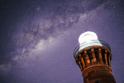 Low angle view of tower against sky at night