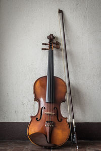 Close-up of violin by wall