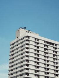 Low angle view of modern building against blue sky