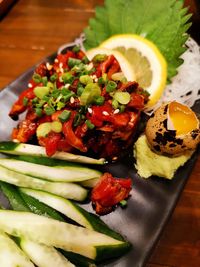 High angle view of chopped fruits in plate on table