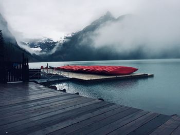 Pier over lake against mountains