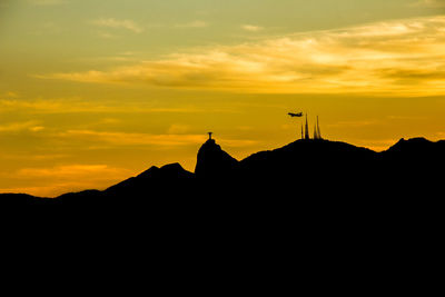 Silhouette mountain against sky during sunset