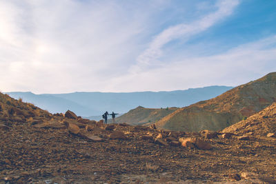 Scenic view of field and mountains against sky