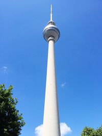 Low angle view of fernsehturm against blue sky