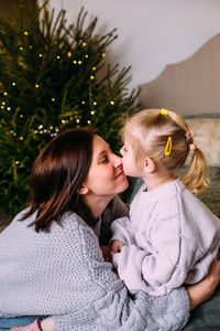 Mother and daughter having fun and relaxing at home. xmas and new year concept