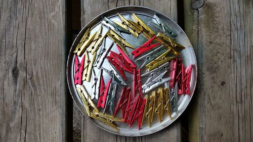 Directly above shot of clothespin on plate on wooden table