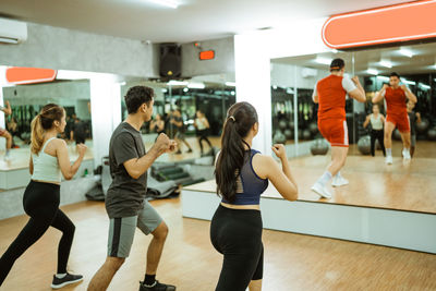 Side view of woman exercising in gym