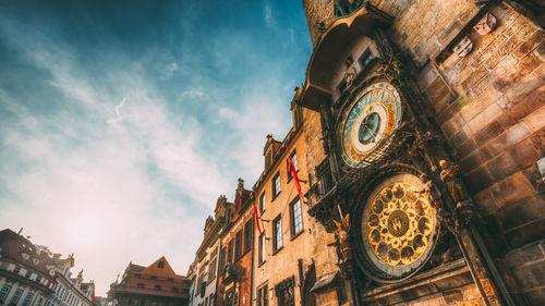 Low angle view of clock tower amidst buildings in city