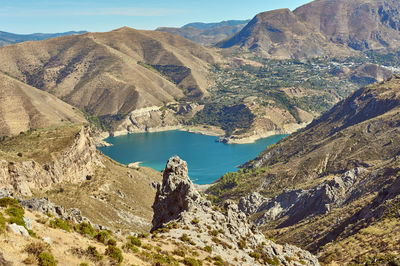 Scenic view of lake and mountains against sky