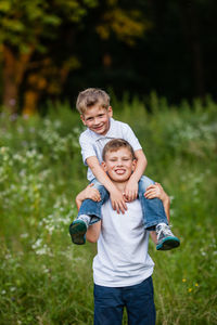 Siblings playing in grass