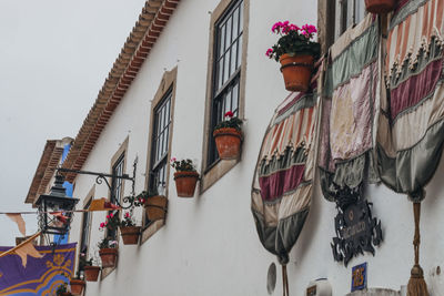 Low angle view of building by wall