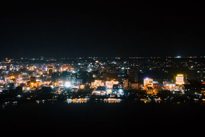 High angle view of illuminated buildings against sky at night