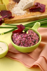 Close-up of spinach porridge with cheese in bowl on table