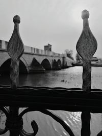 Close-up of sculpture by bridge against sky