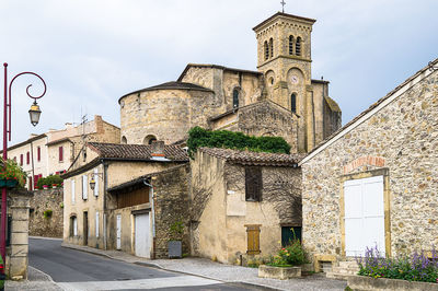 Low angle view of street amidst buildings against sky