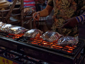 Vendor cooking fish on the street