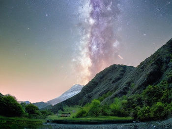 Scenic view of mountains against sky at night