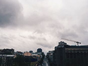 Buildings in city against cloudy sky