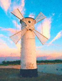 Traditional windmill against sky