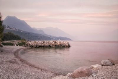 Scenic view of sea and mountains against sky