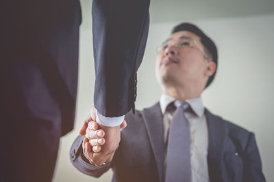 Low angle view of businessmen doing handshake