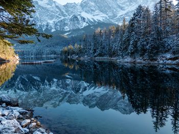 Scenic view of snowcapped mountains and lake during winter