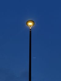 Low angle view of street light against clear blue sky