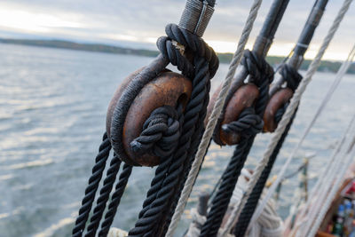 Close-up of pulleys against sea