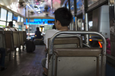 Rear view of man sitting in train